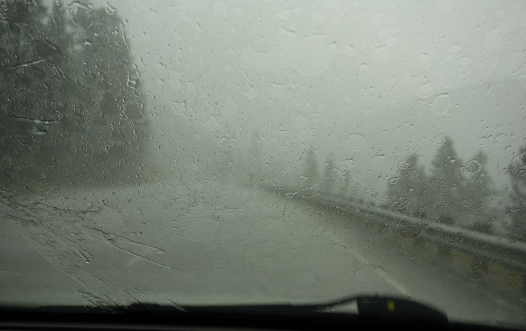 A Car Moving on Hilly Road While it is Raining