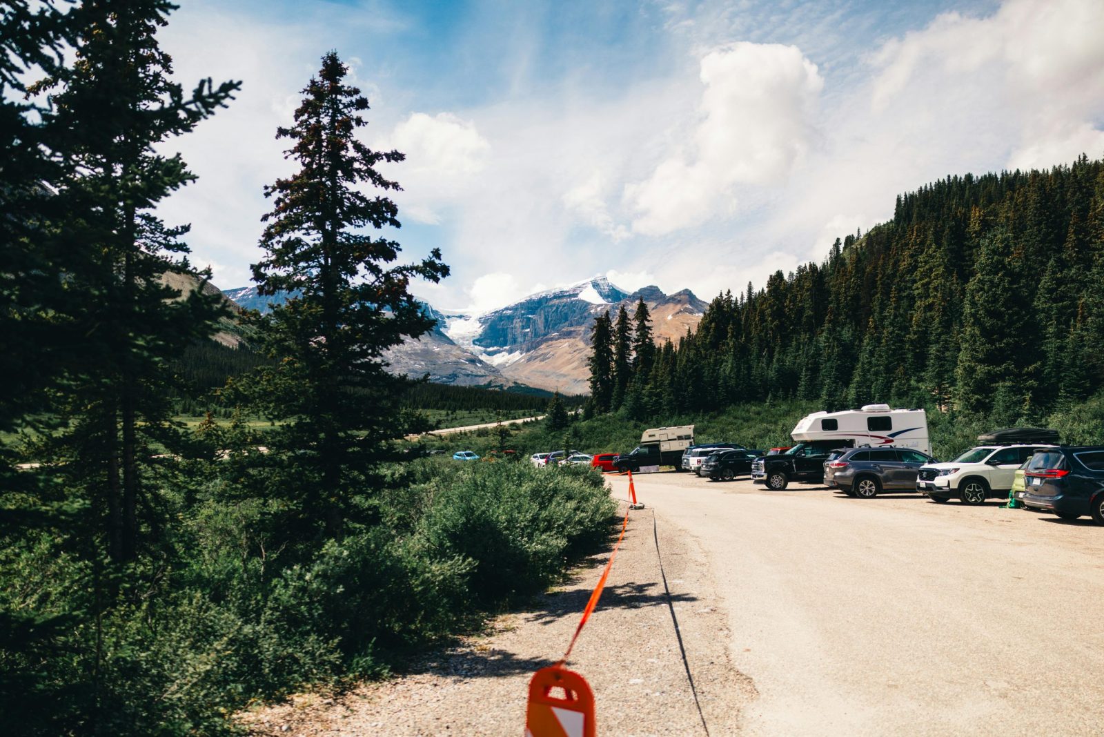 Camper vans parked along a mountain road.
