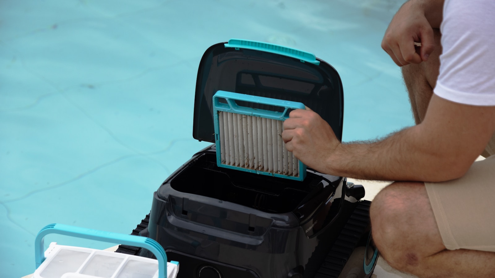 A person removes the filter cartridge from a portable water filter