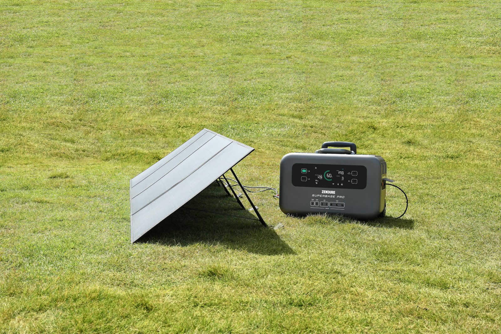A portable solar charger sitting in the middle of a field