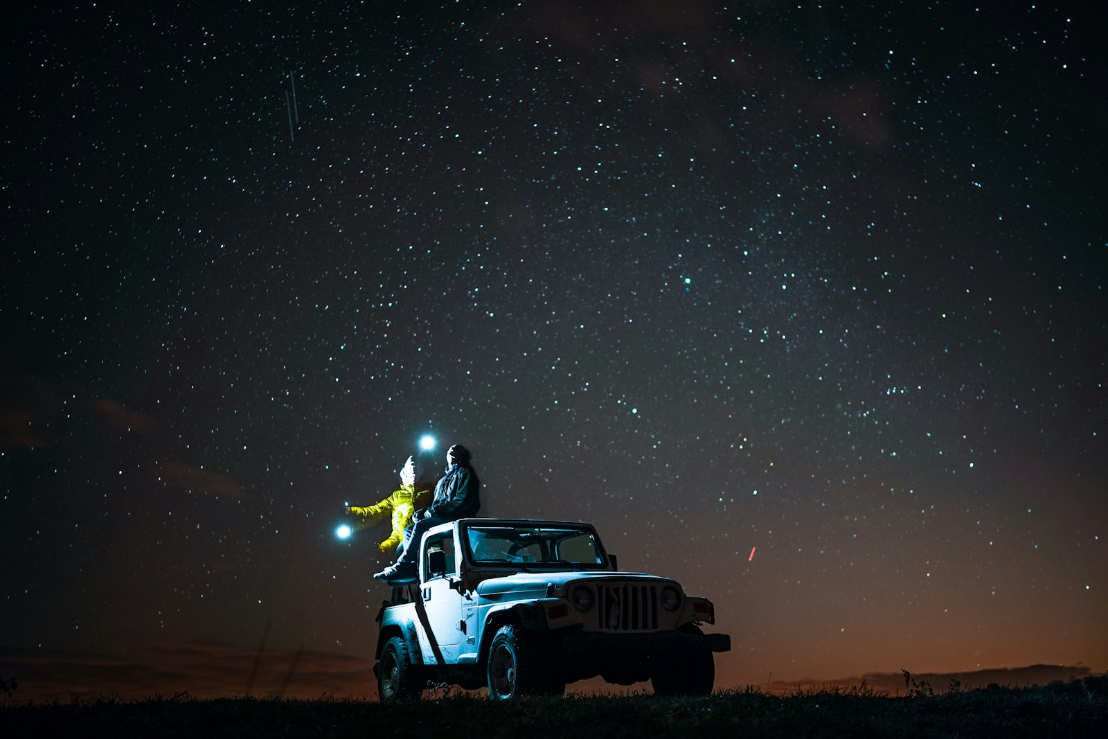 taiki-ishikawa-w6EMxsk8CDA-unsplash Person sitting on top of wrangler under starry sky