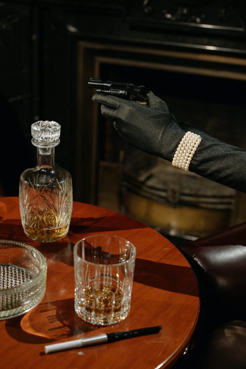 A gloved hand with a gun.