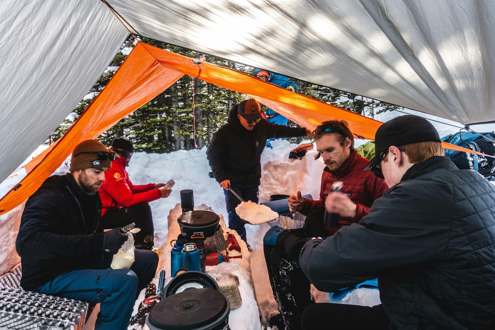 Hiker's Sitting at a Table Inside a Tent