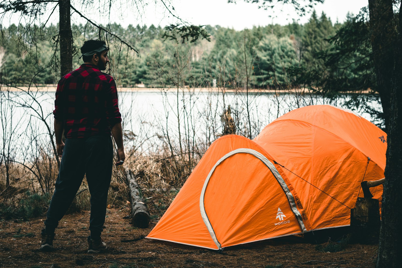 A man standing next to a tent