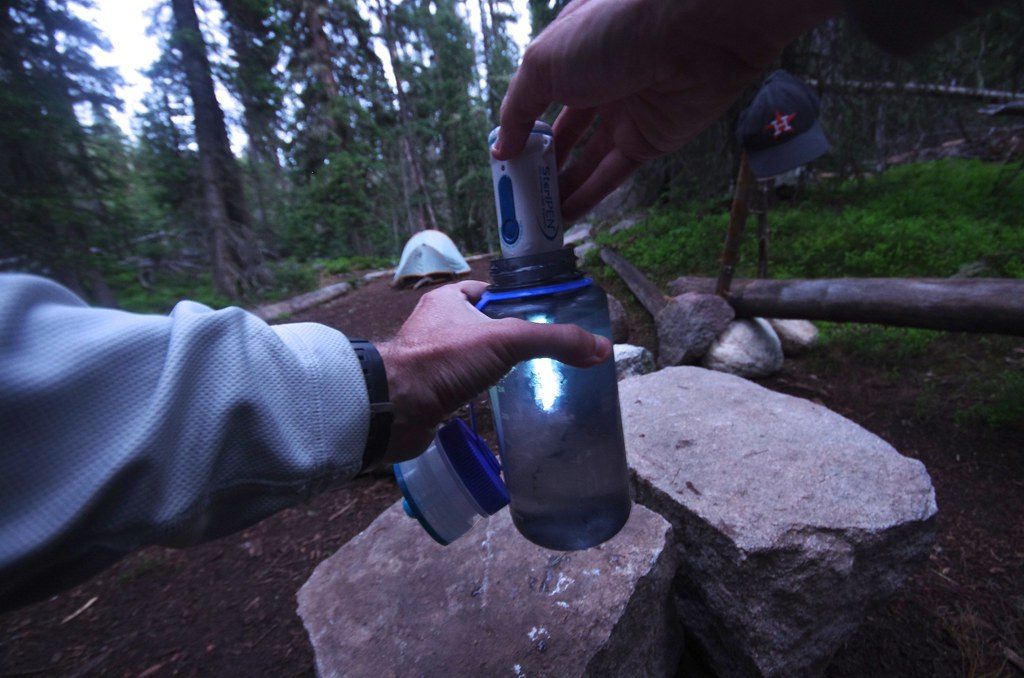 A Man Purifying Water Using UV