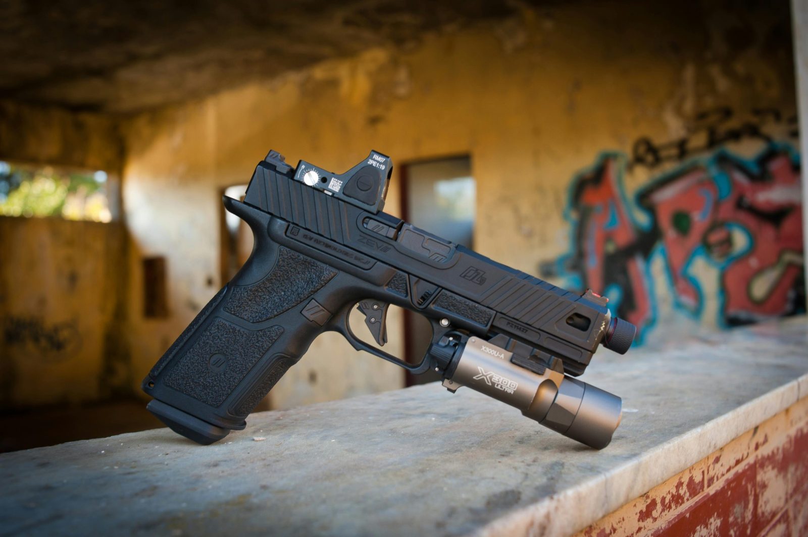 taiki-ishikawa-w6EMxsk8CDA-unsplash A modern black handgun with flashlight.