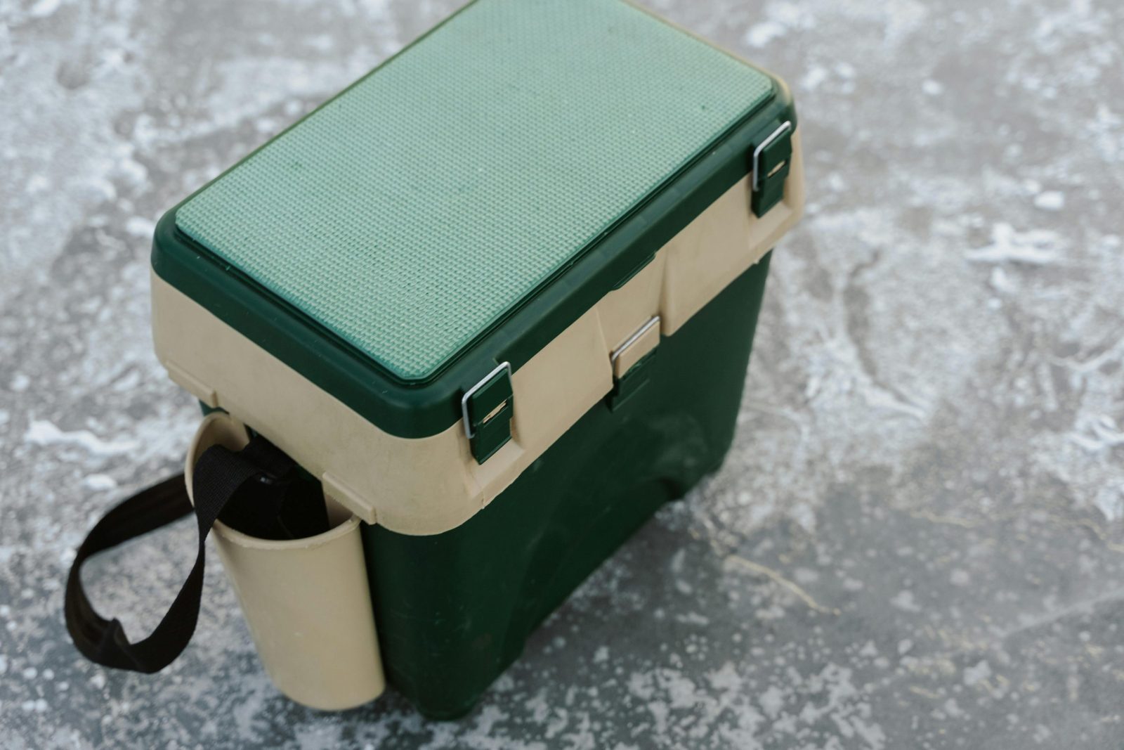A green and beige cooler ideal for outdoor adventures.