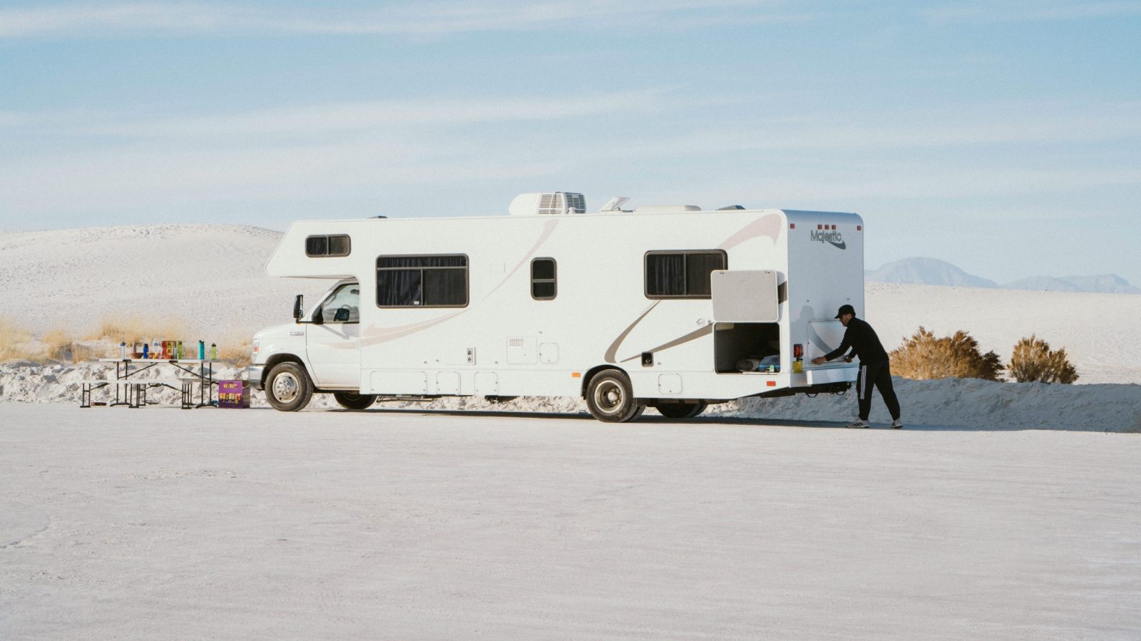 A camper van parked in a sunny desert