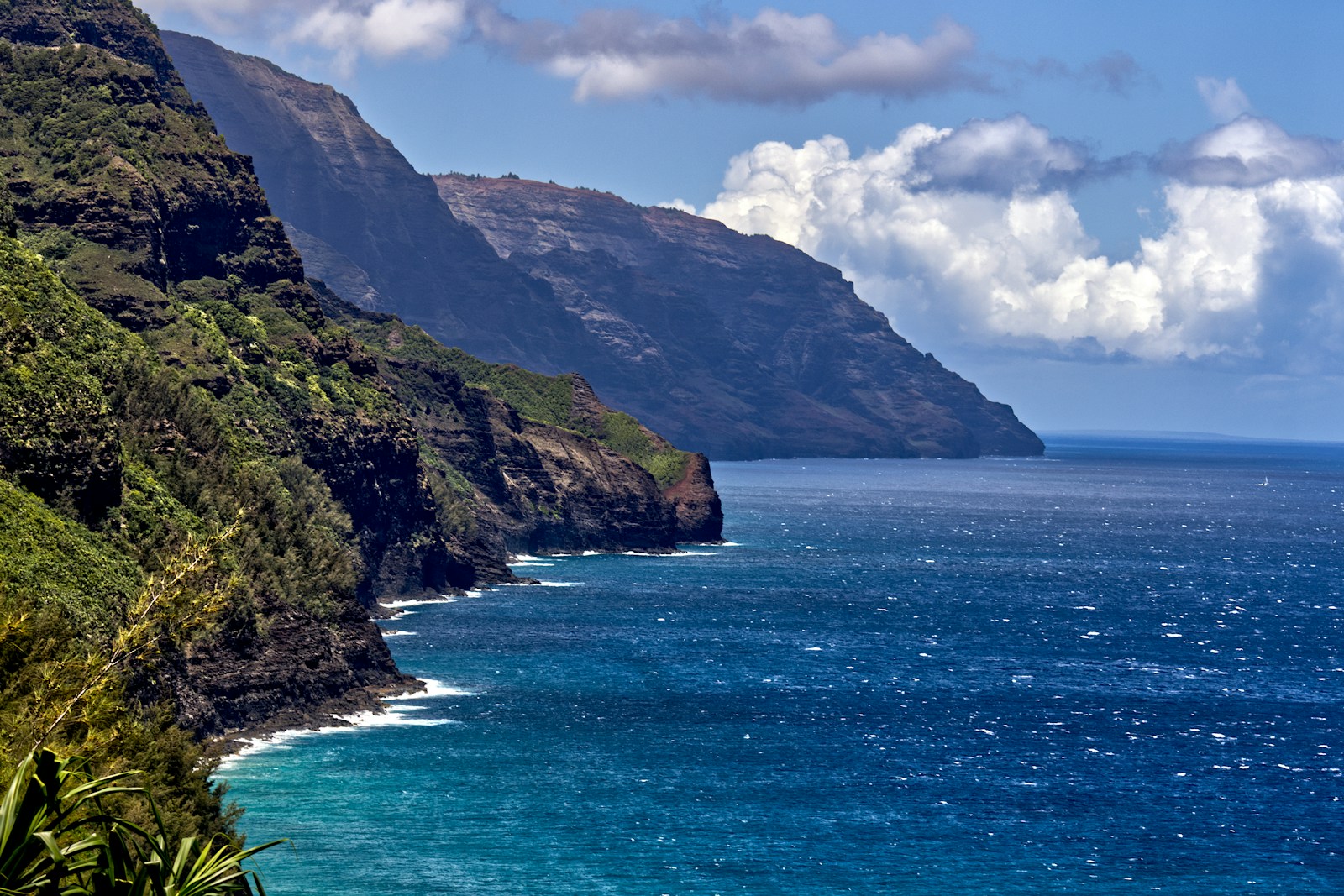 Scenic view of the ocean with a mountain in the background