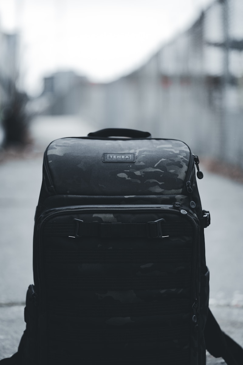 a black backpack sitting on the ground