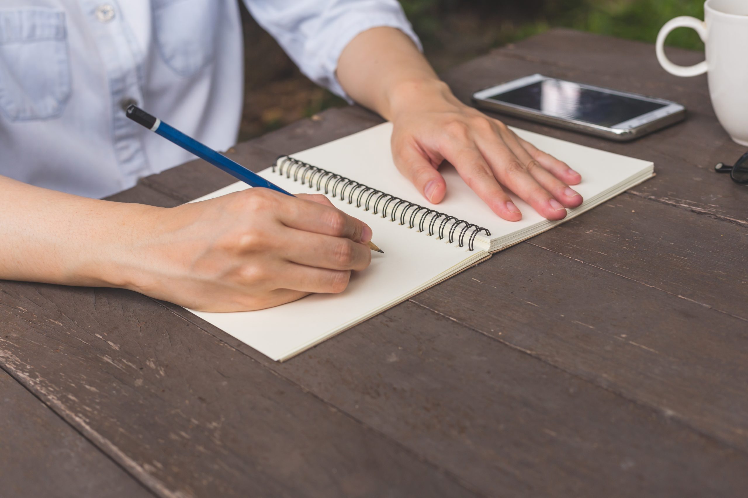 A person writing letter