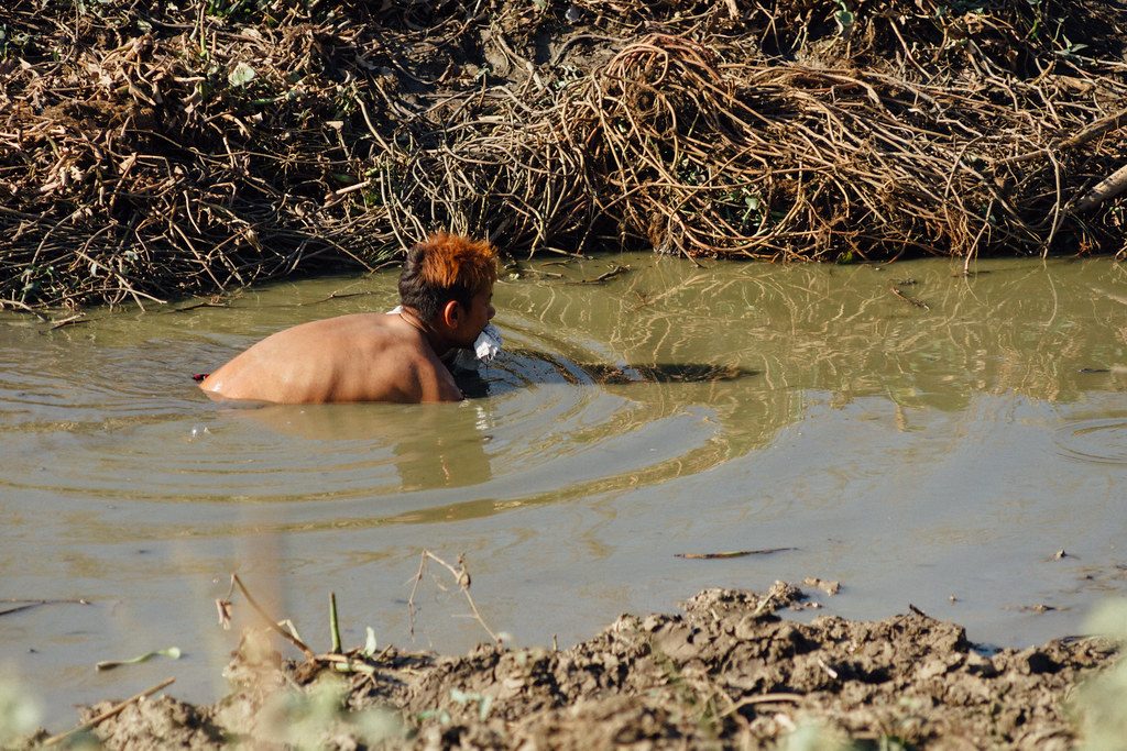 Man Fishing by Hand