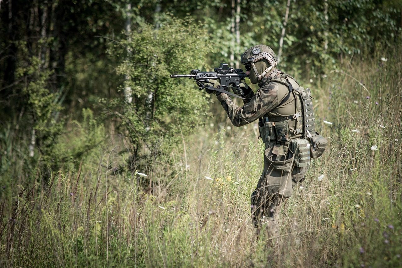 taiki-ishikawa-w6EMxsk8CDA-unsplash A Soldier Holding a Rifle and Aiming.