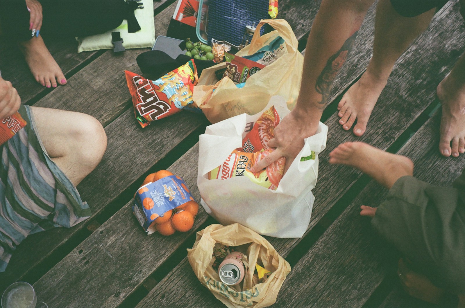 a group of people sitting on a wooden bench