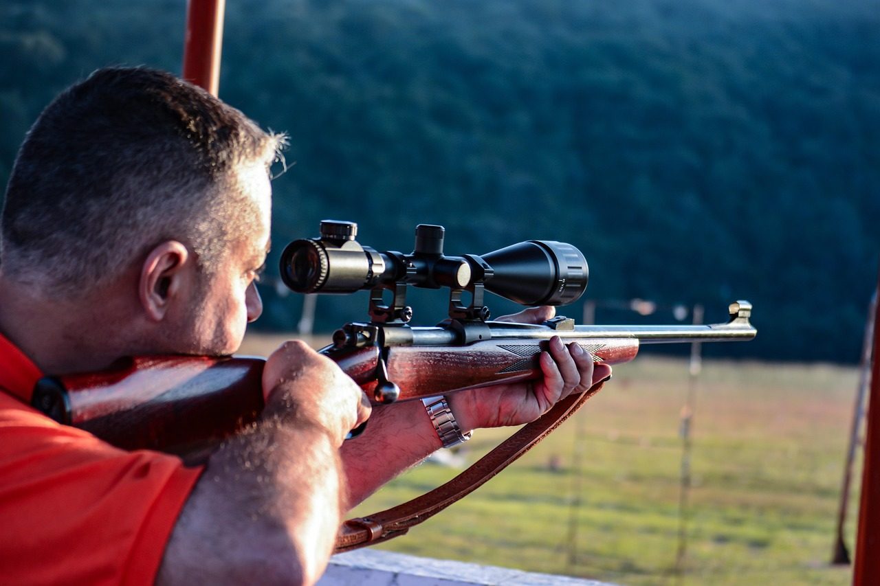 A Man Pointing his Hunting Rifle 