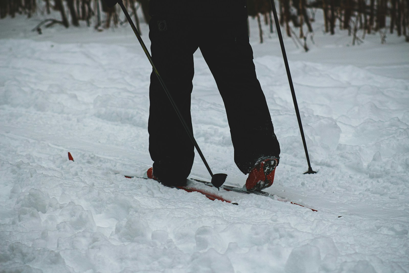 A Hiker Wearing Thermal Socks While Hiking in Snowy Region