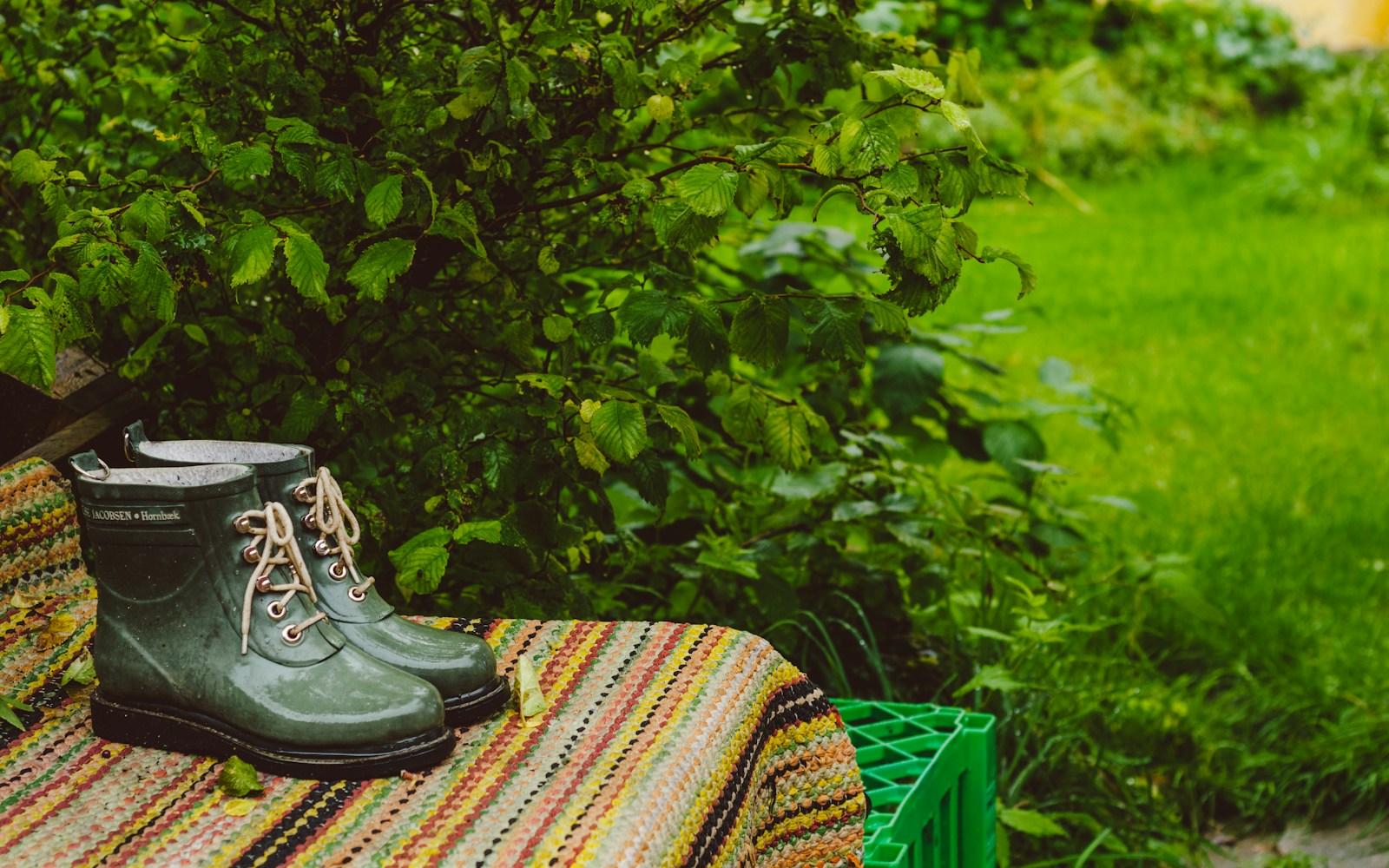 black leather boots on brown and beige textile