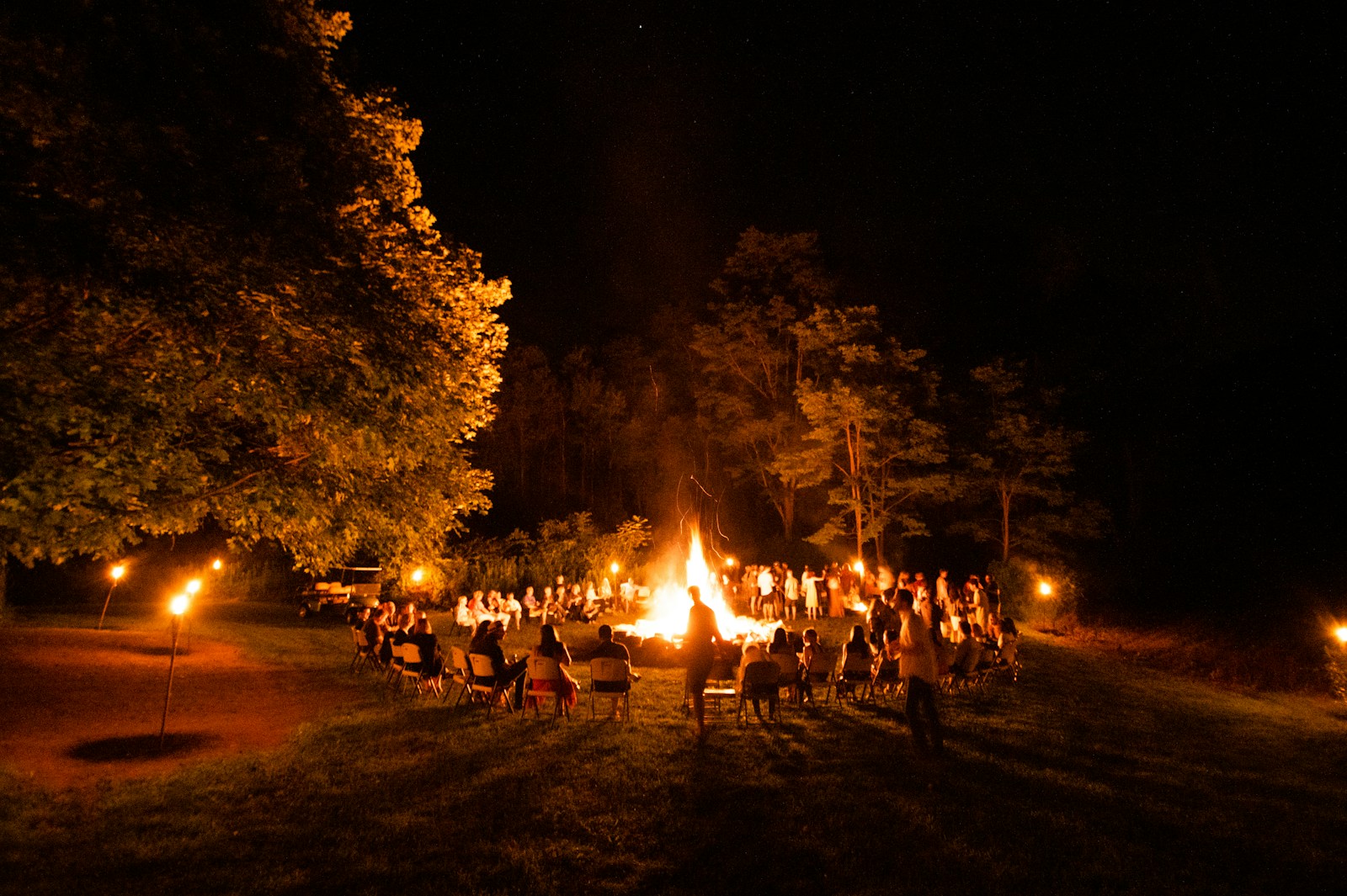 A Group of People Sitting Around Fall Campfire