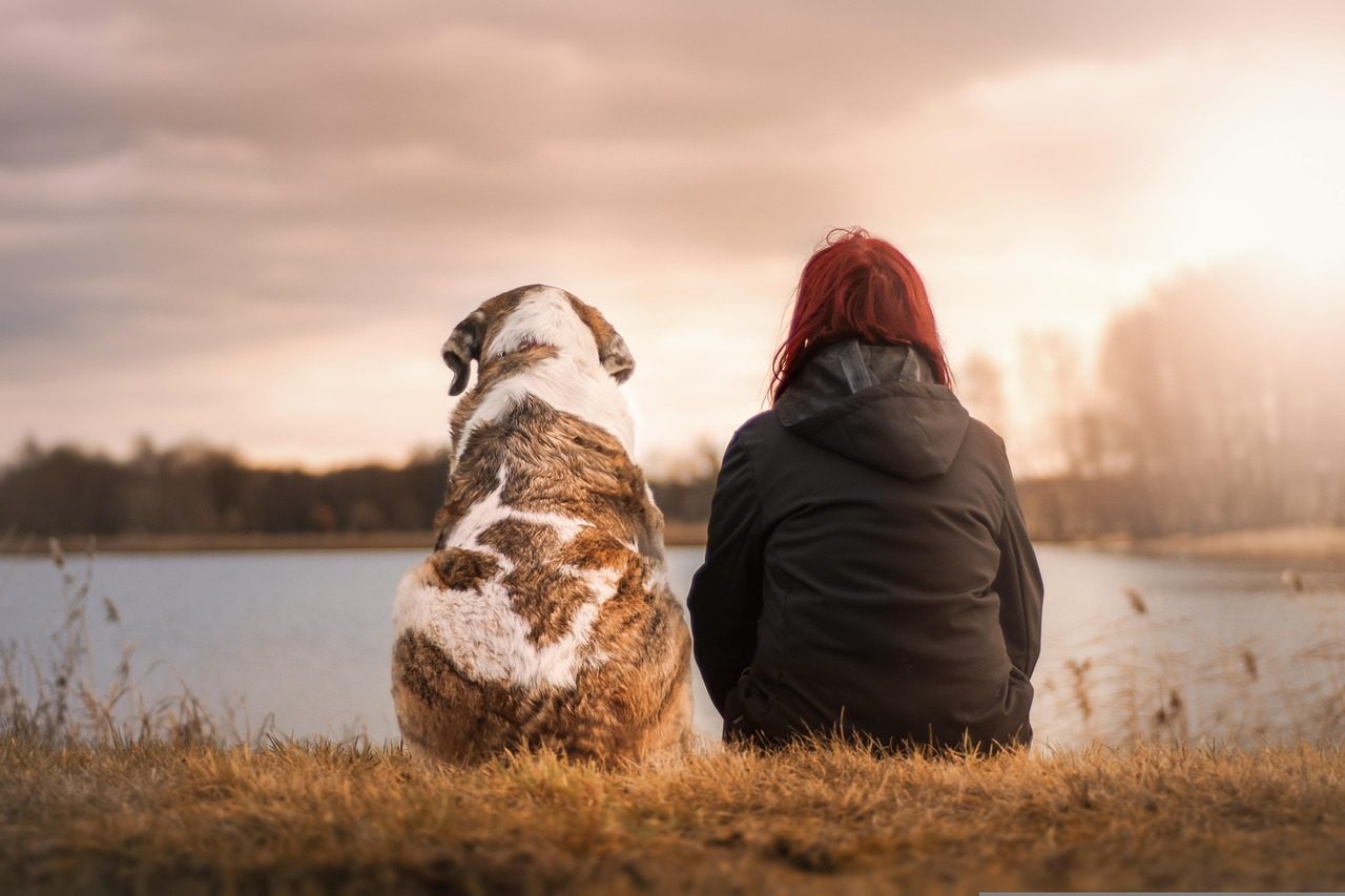 A Woman Sitting with a Dog