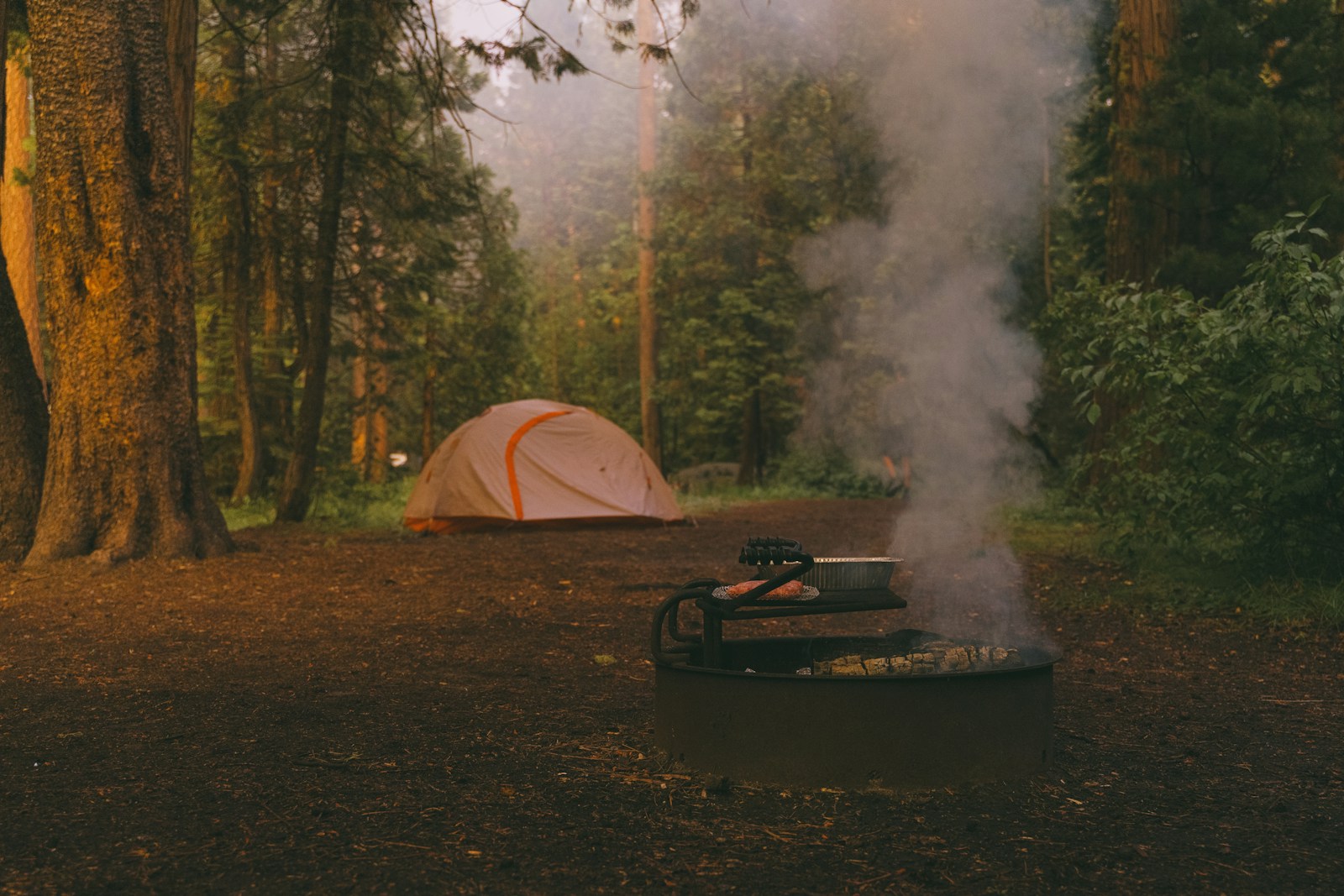 taiki-ishikawa-w6EMxsk8CDA-unsplash A campfire with a tent in the background