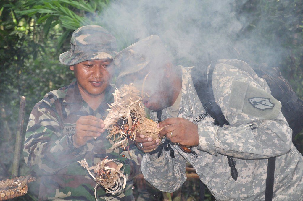 Two Man Trying to Ignite Fire in Wilderness
