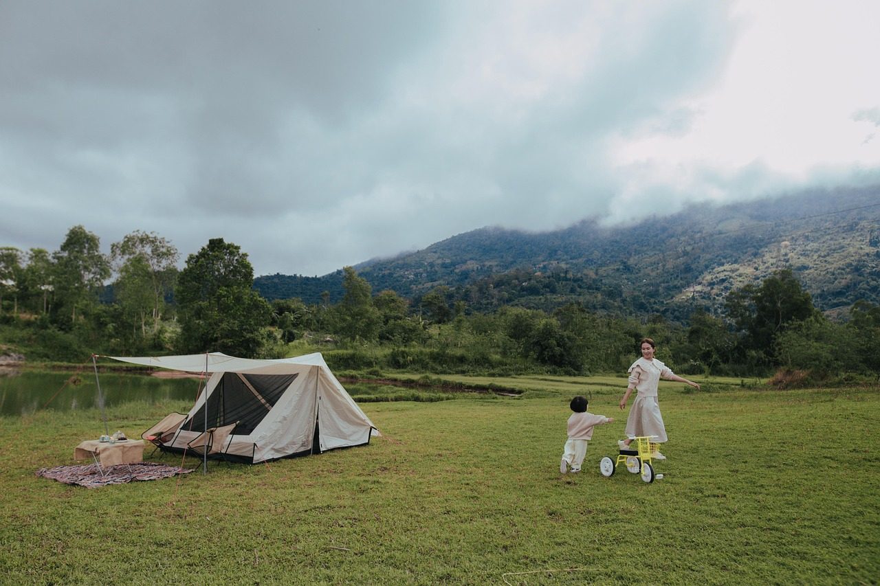 A Mother and a Child Playing in a Scenic Campsite