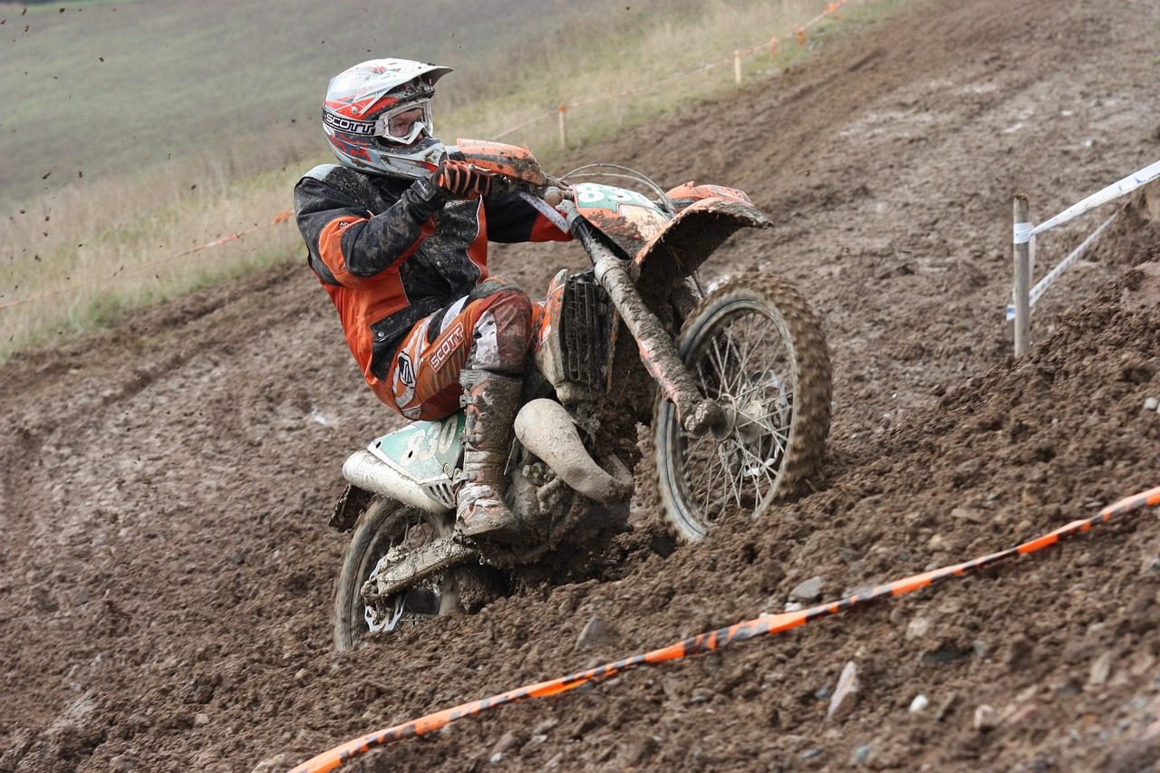 A Dirt Racer Riding his Bike on a Dirt Track