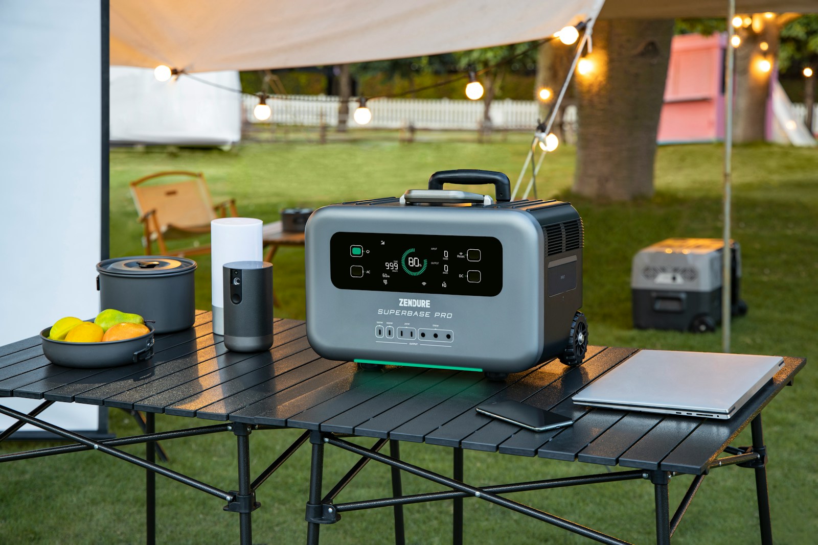a table with a cooler and a laptop on it and a portable generator in background