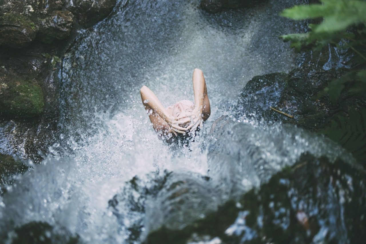 A Woman Bathing in Waterfall