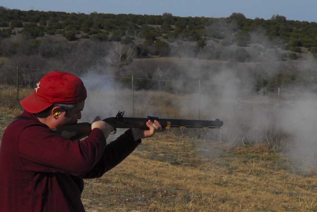 A Person Firing a Rifle