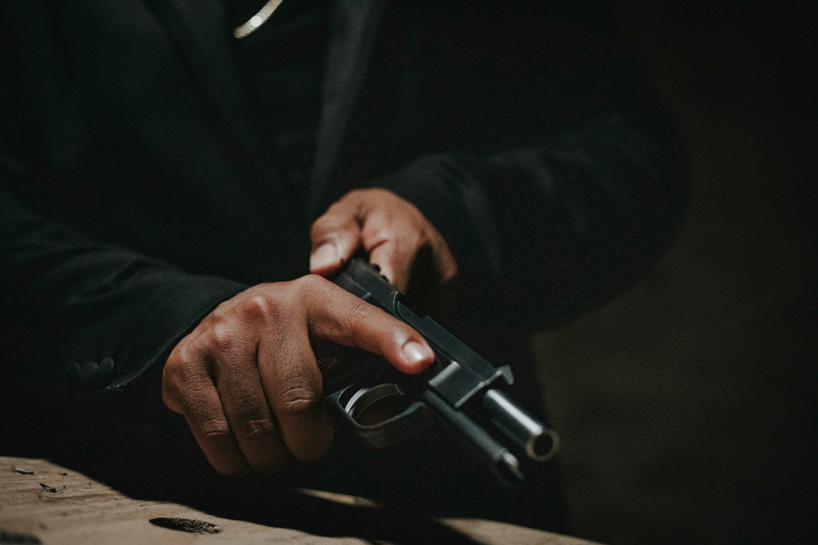 a man holding a gun in his right hand