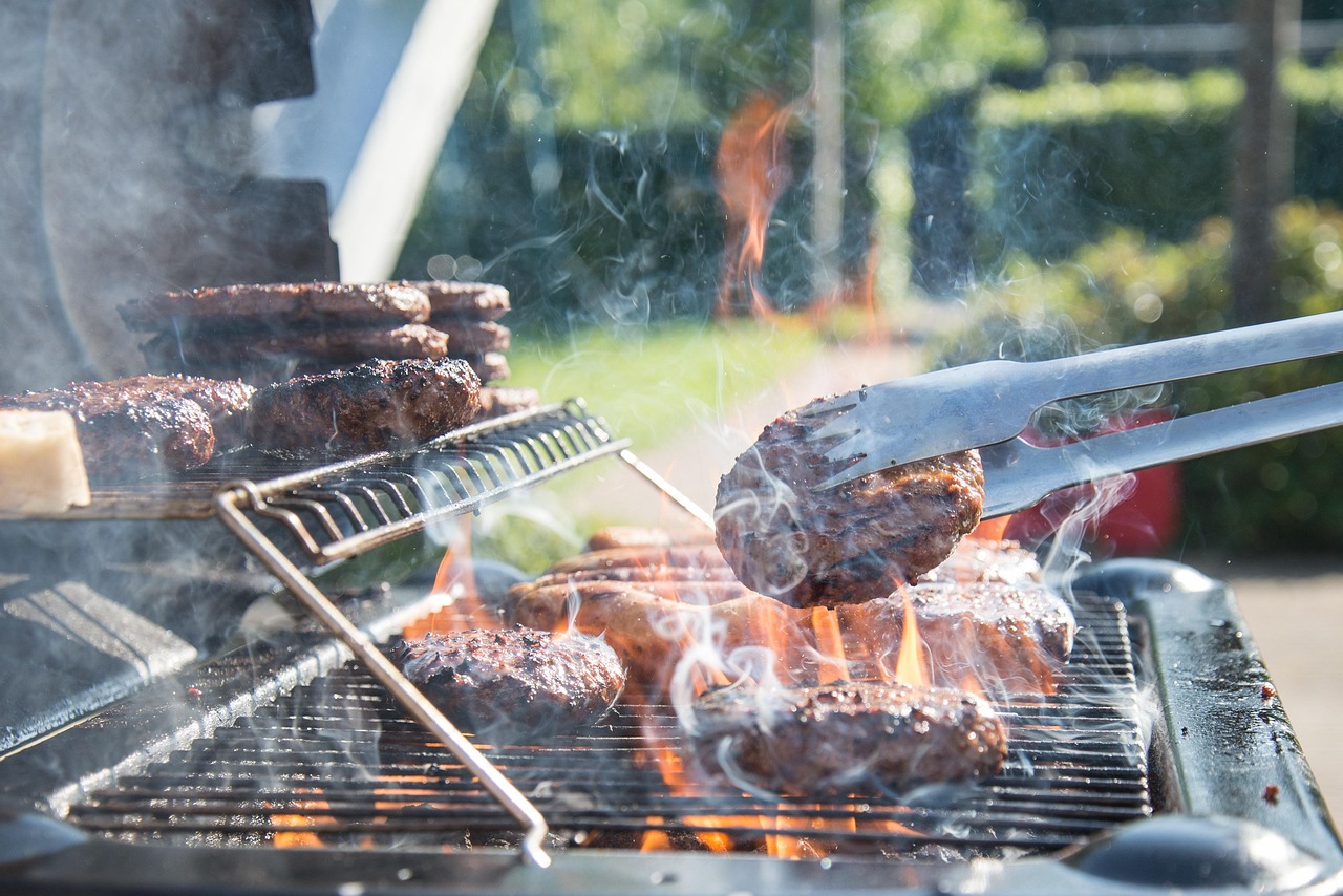 Campers Heating Food on a Barbecue