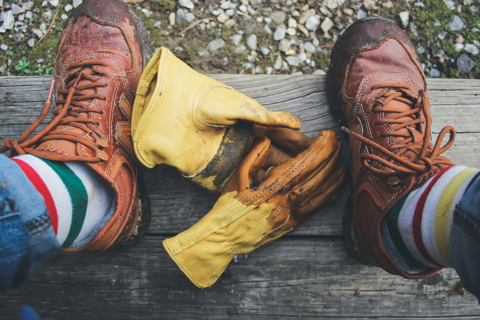 A Person Cleaning his Shoes Using Yellow Gloves
