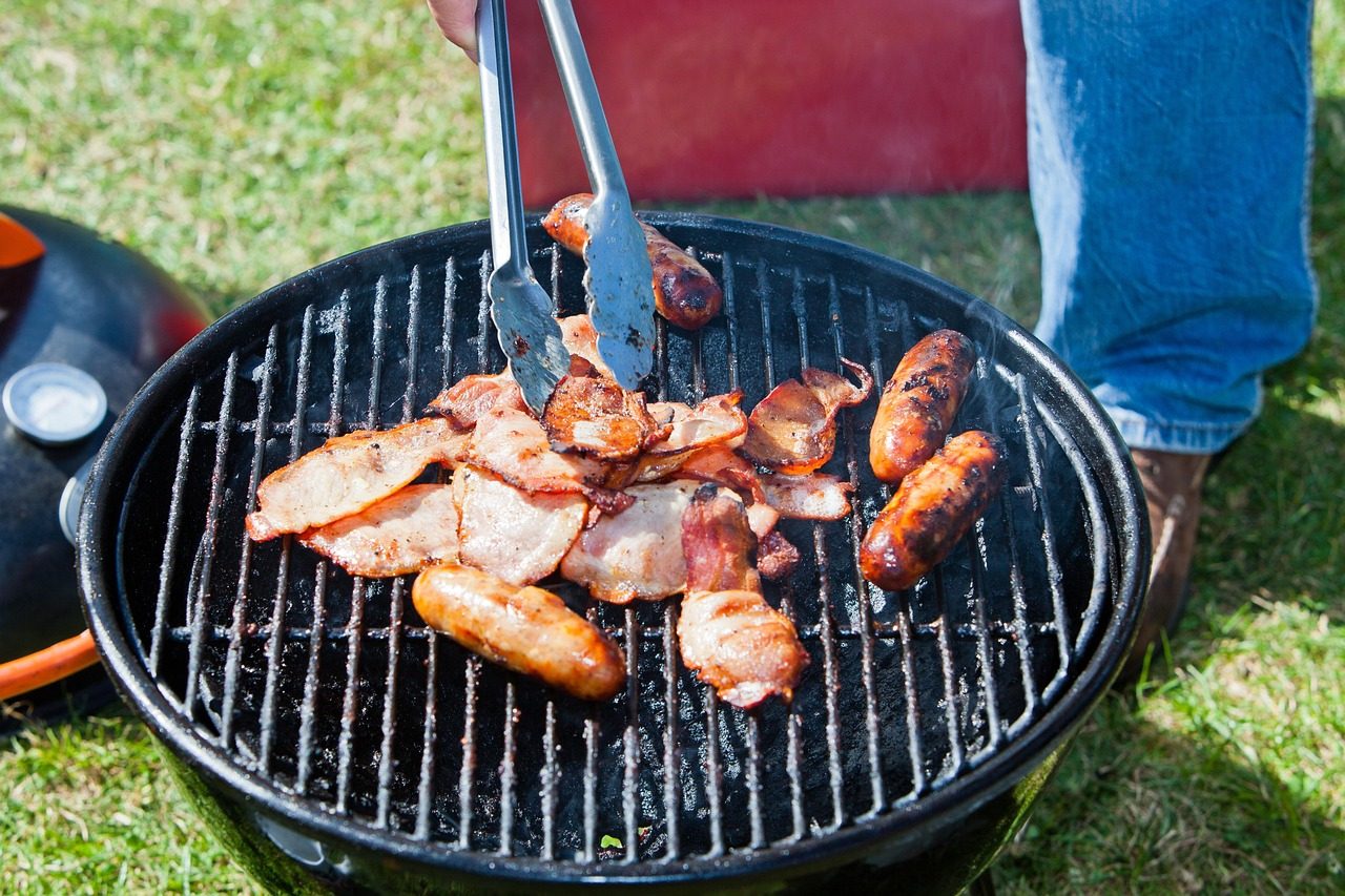 A Person Grilling on a Charcoal Portable Stove