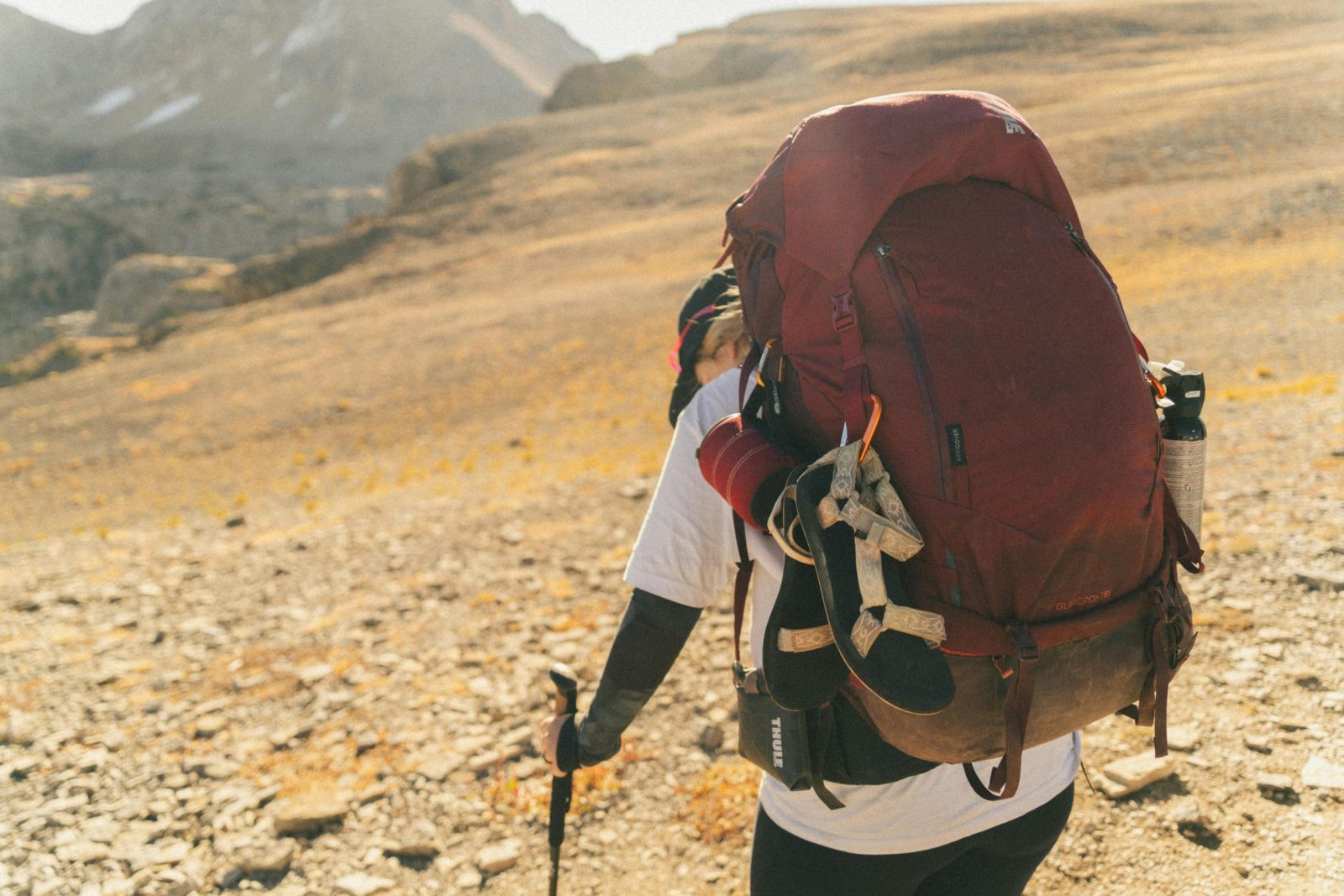 A Man Hiking in a Deserted Hilly Area