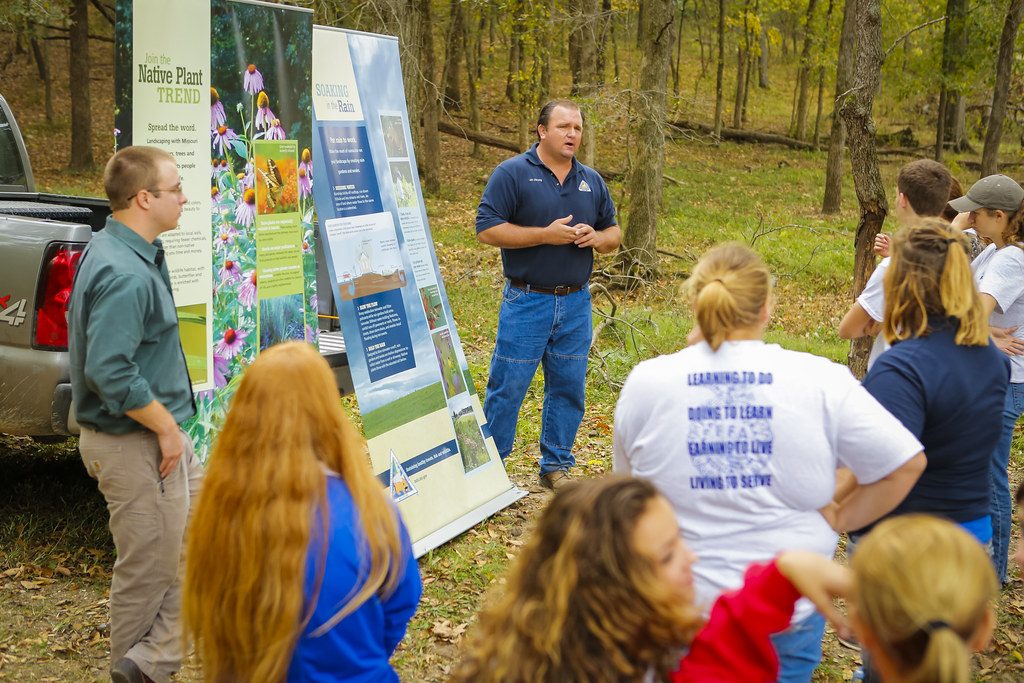 A Conservation Specialist Talking to Group of People