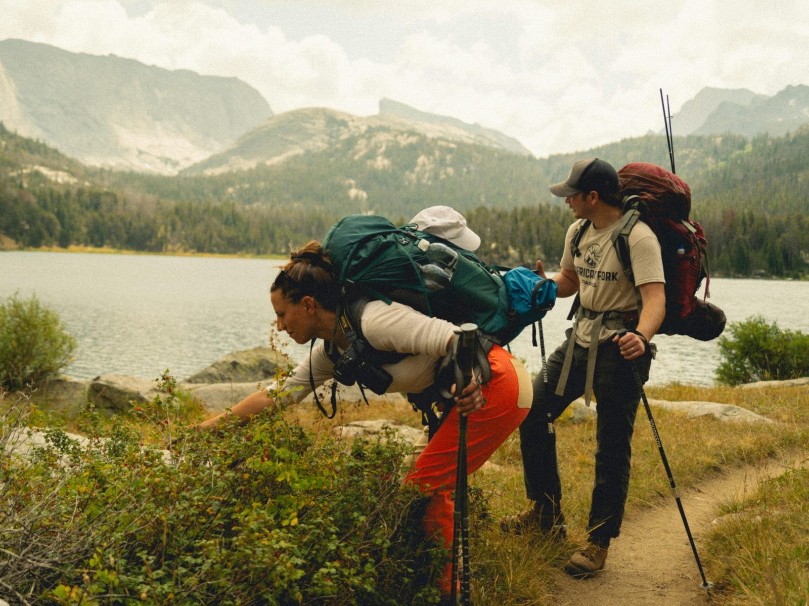 Two hikers trekking through the scenic landscapes of Wind River Range, Wyoming.