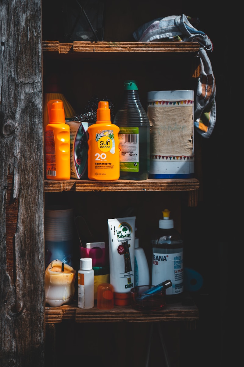 assorted cleaning bottles on brown wooden shelf