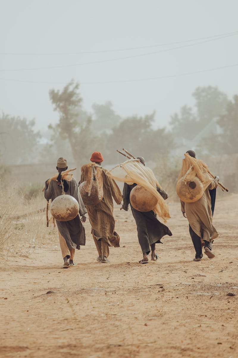 Men Wearing Traditional Clothing on Desert