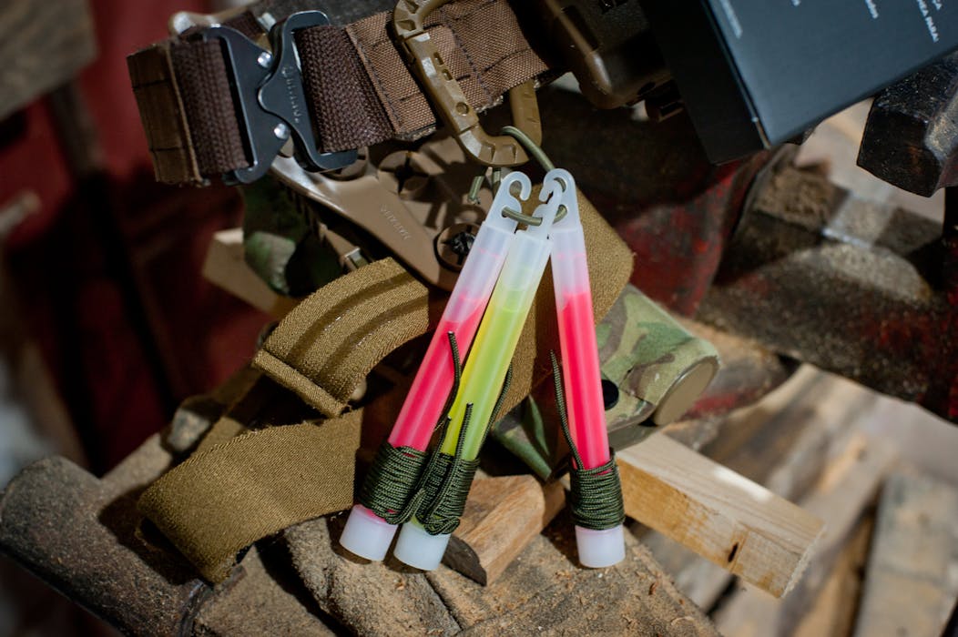 Colorful Glow Sticks and Tactical Gear Arrangement