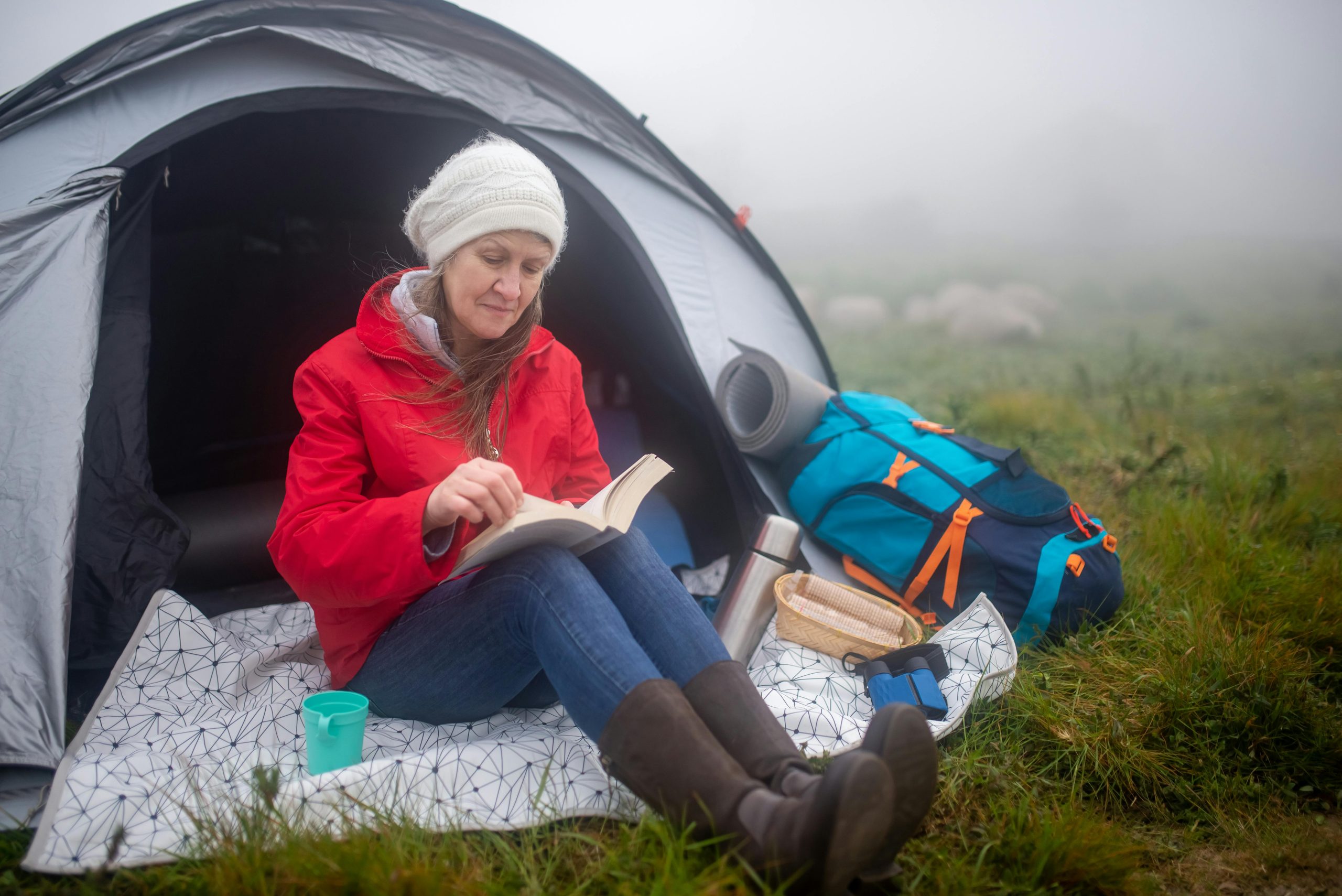 A Woman Wearing Sweater and Reading a Book