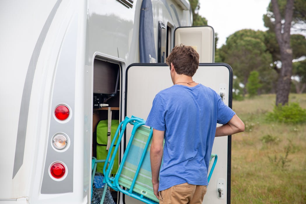 Man Bringing Beach Chair into RV