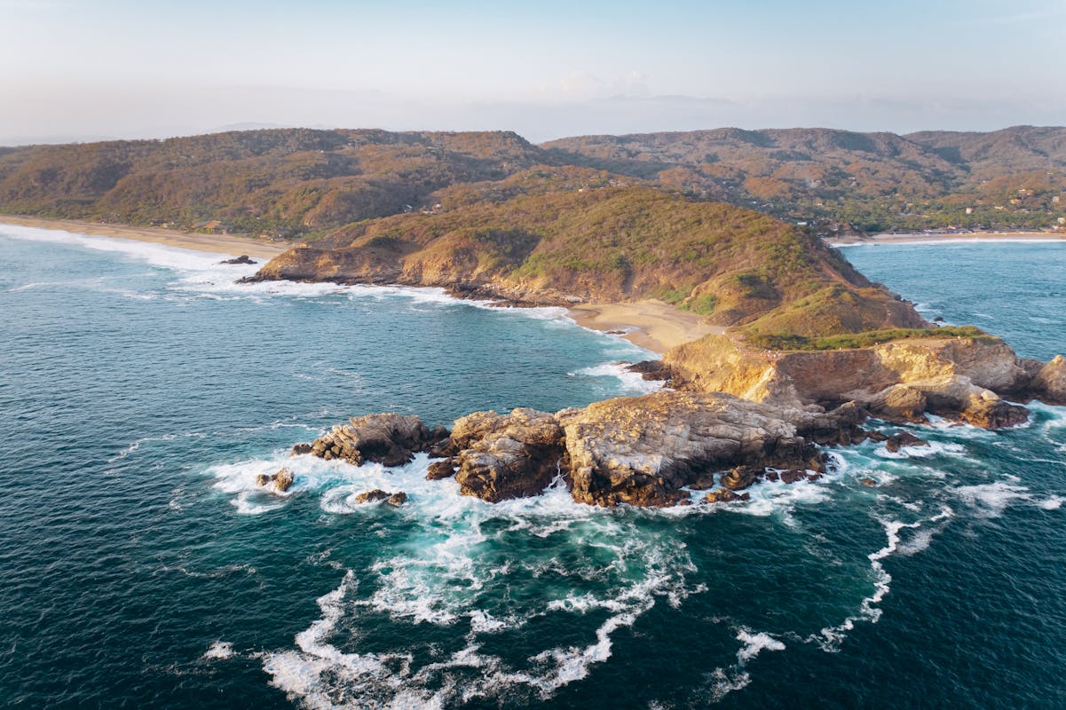 Green and Brown Island Beside Blue Sea in New Mexico