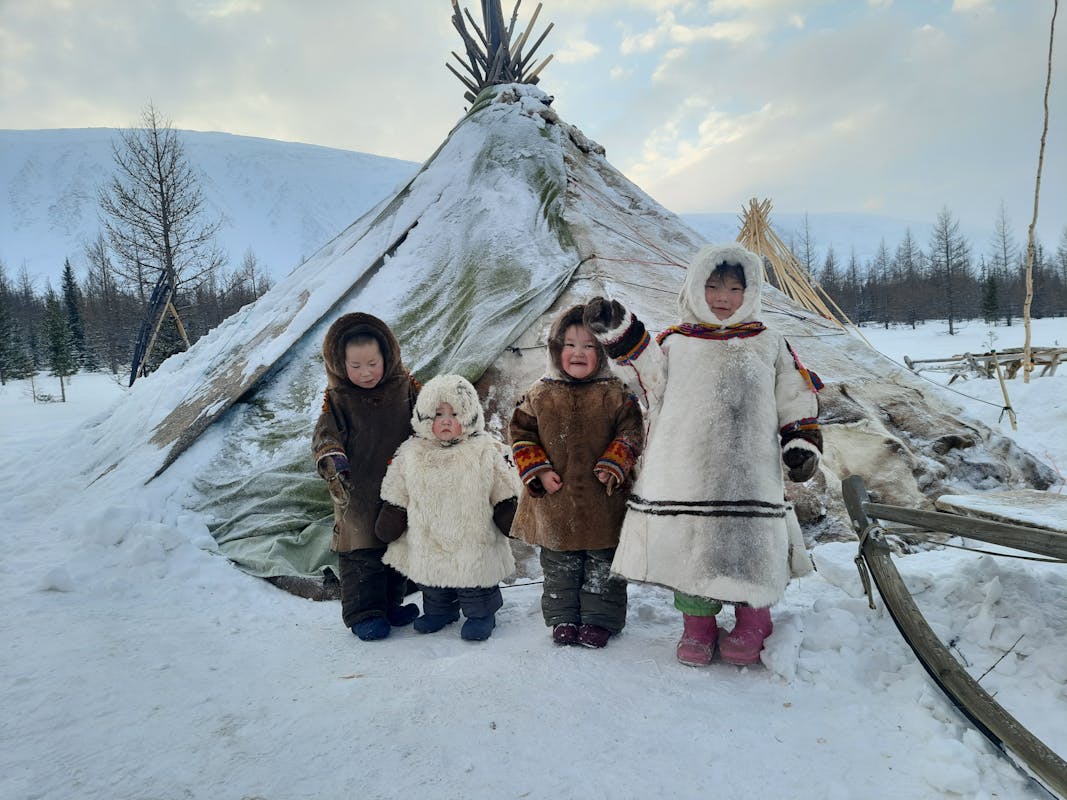 Children in Warm Fur Coat Standing in Front of Tent