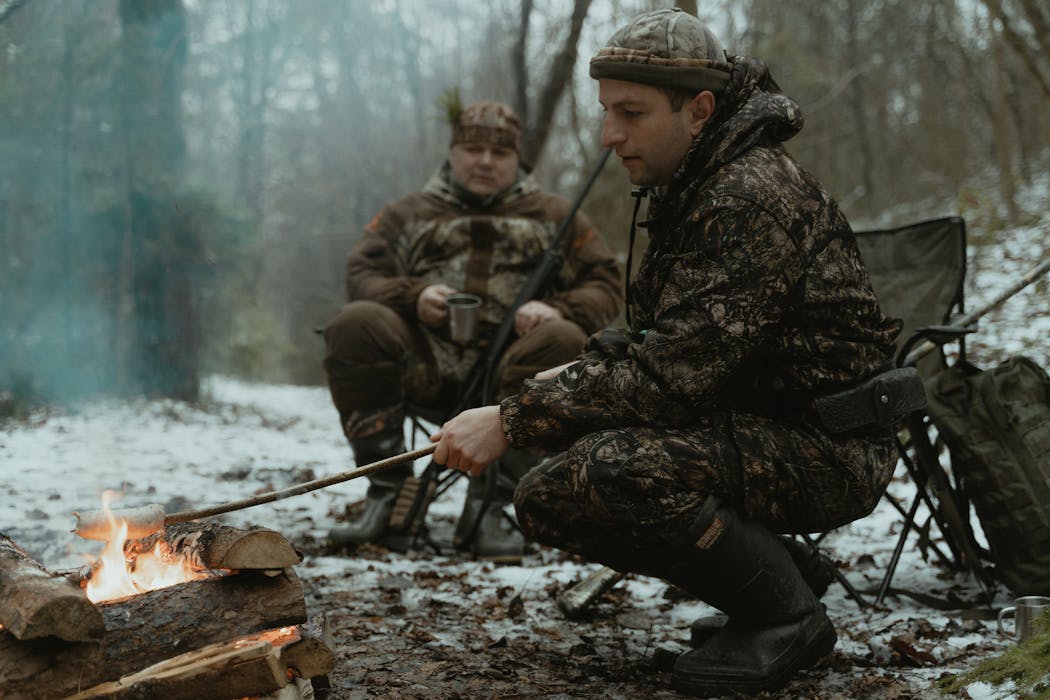 Men Sitting Beside a Bonfire Discussing