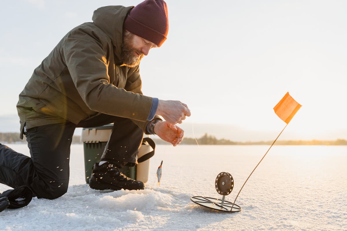 A Person Fishing in Iced Lake