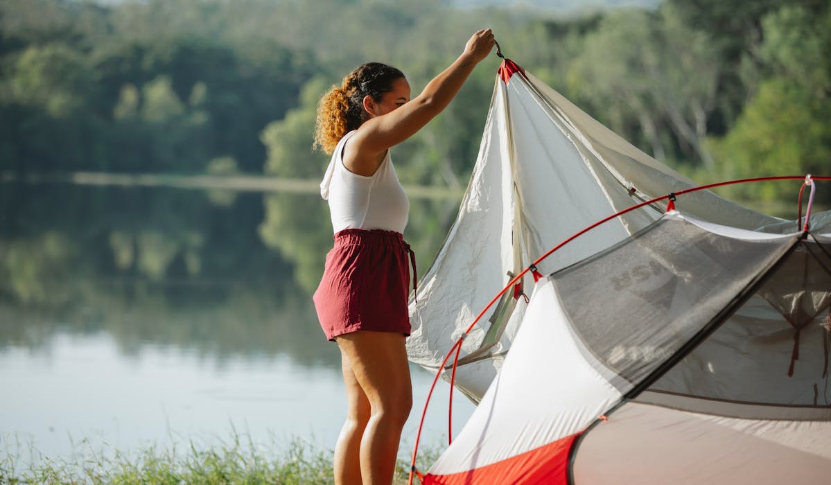 A Person Setting up Insect Protection Tent