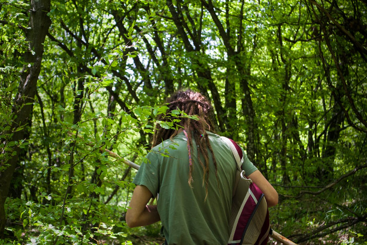 Man Wearing a Backpack Walking in the Woods