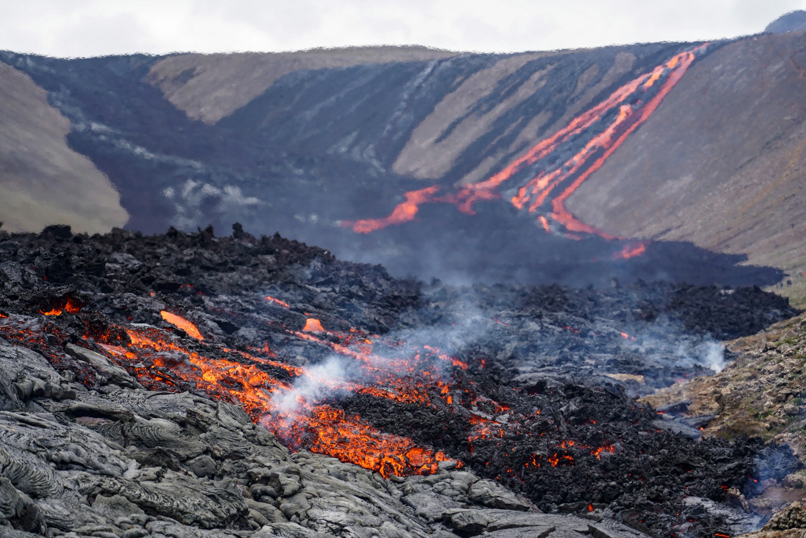 A large amount of lava and rocks with a mountain