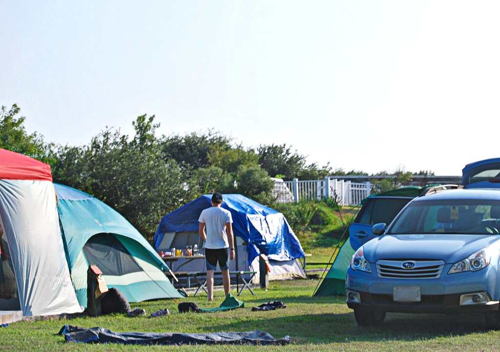 A Car, A Tent in A Camping Ground Positioning the Tent Door Leeward